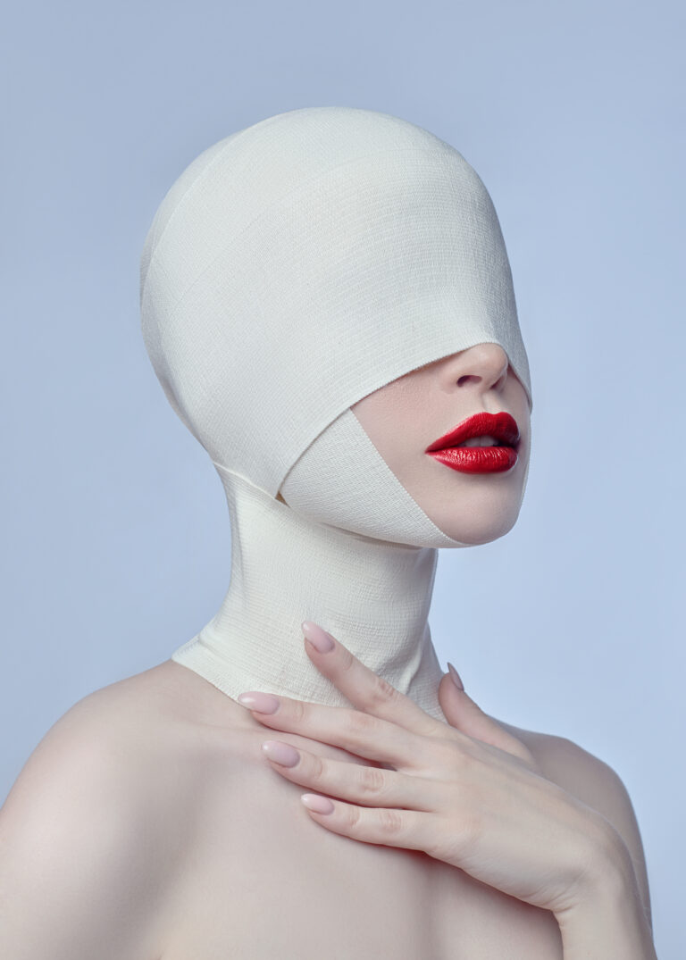 Plastic surgery, cosmetic surgery on face woman. Face bandaged with medical bandages. Woman after plastic surgery skin tightening