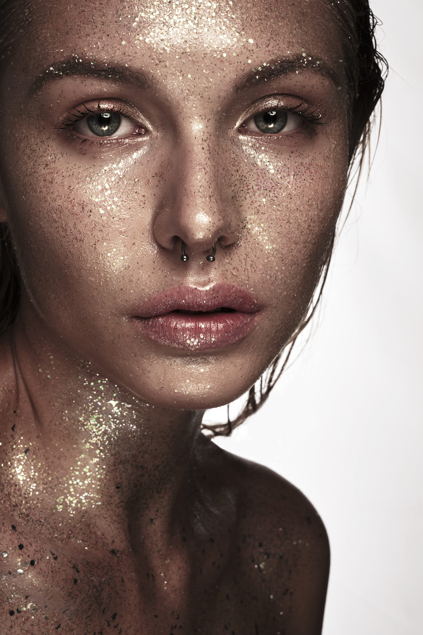 Portrait of beautiful woman with art glitter makeup on her face,